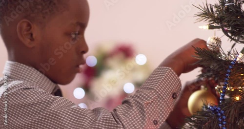 Young boy drops an ornament he is trying to hang - shot on RED photo