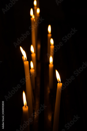 Row of light candles in a church