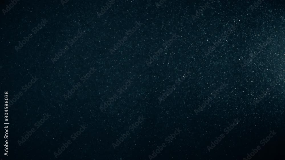 Natural Organic Dust Particles Floating On Black Background. Dynamic Dust Particles Randomly Float In Space With Fast And Slow Motion. Shimmering Glittering White Particles With Bokeh In The Air. Natural Organic Dust Particles Floating On Black Background. Dynamic Dust Particles Randomly Float In Space With Fast And Slow Motion. Shimmering Glittering White Particles With Bokeh In The Air.