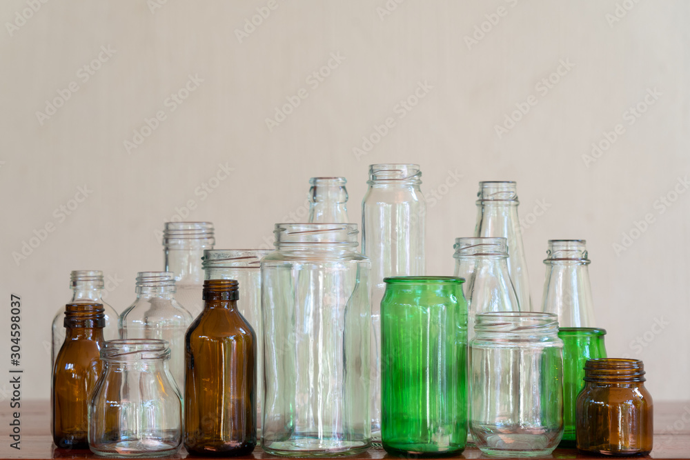 Variety shape and color of empty glass container bottles, reuse things concept Variety shape and color of empty glass container bottles, reuse things concept