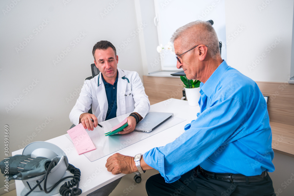 Doctor discuss with his elder patient at his office Doctor discuss with his elder patient at his office