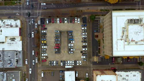 Aerial view from above flying drone parking lot in modern city. Car traffic and parking concept. photo