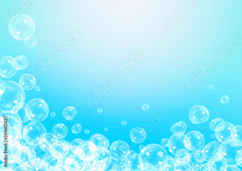 Soap bubbles on a blue background with copy space