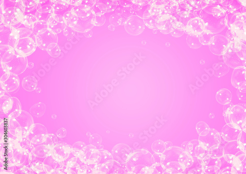 Soap bubbles frame on pink background with copy space