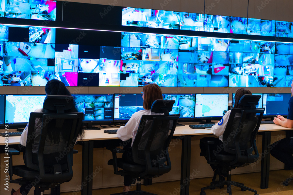 Team of secret agents in uniforms, monitoring cyber, video and communications at the main control data center station. Team of secret agents in uniforms, monitoring cyber, video and communications at the main control data center station.
