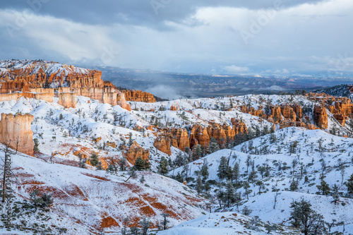 Red sandstone towers of Bryce Canyon, Cedar Breaks under fresh snow in Utah.