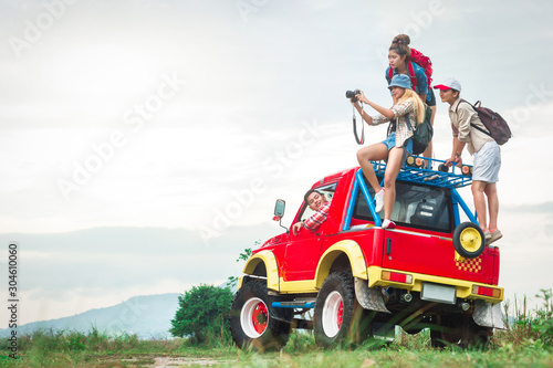Group of Traveler watching idyllic landscape on hiking car. Friends or tourists with colorful backpacks on hiking car. Summer vacation. Travelling  hiking