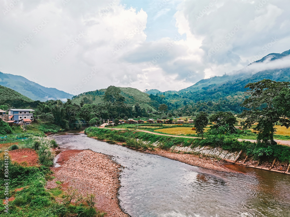mountain landscapes pass the river with blue sky and  weather's fine in Nan province of Thailand