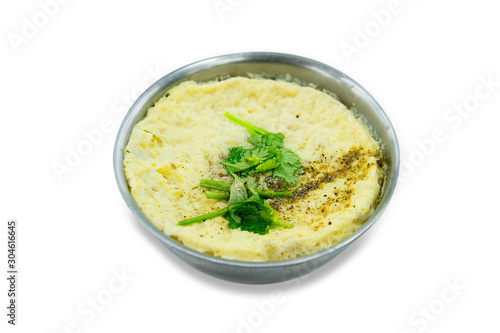 Steamed egg with celery on a stainless steel round bowl