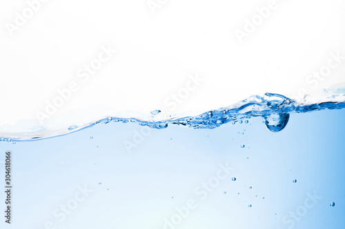 Blue water waves and bubbles in drinking water. Isolated background