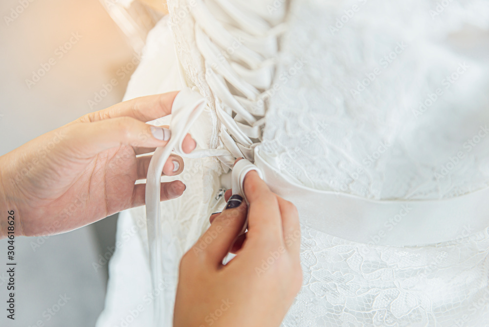 costume designer hands tie the bride dress costume designer hands tie the bride dress