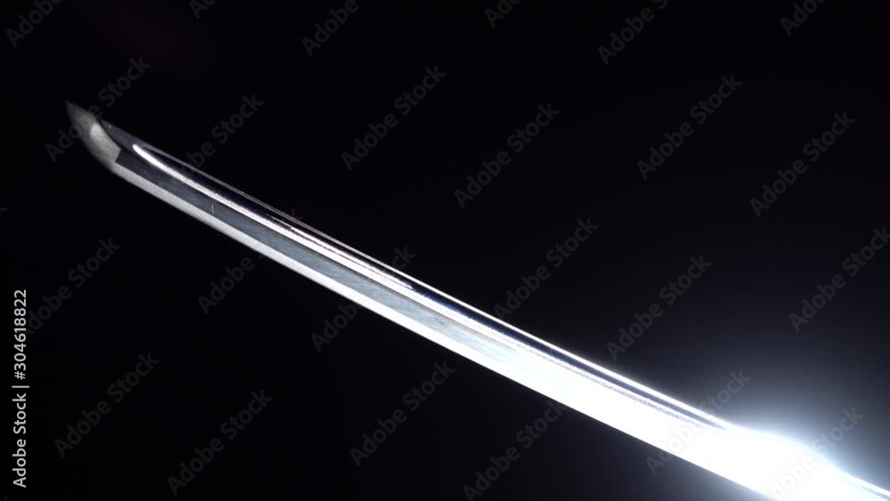 Dramatic studio shot of man holding samurai sword. Close up Dramatic studio shot of man holding samurai sword. Close up