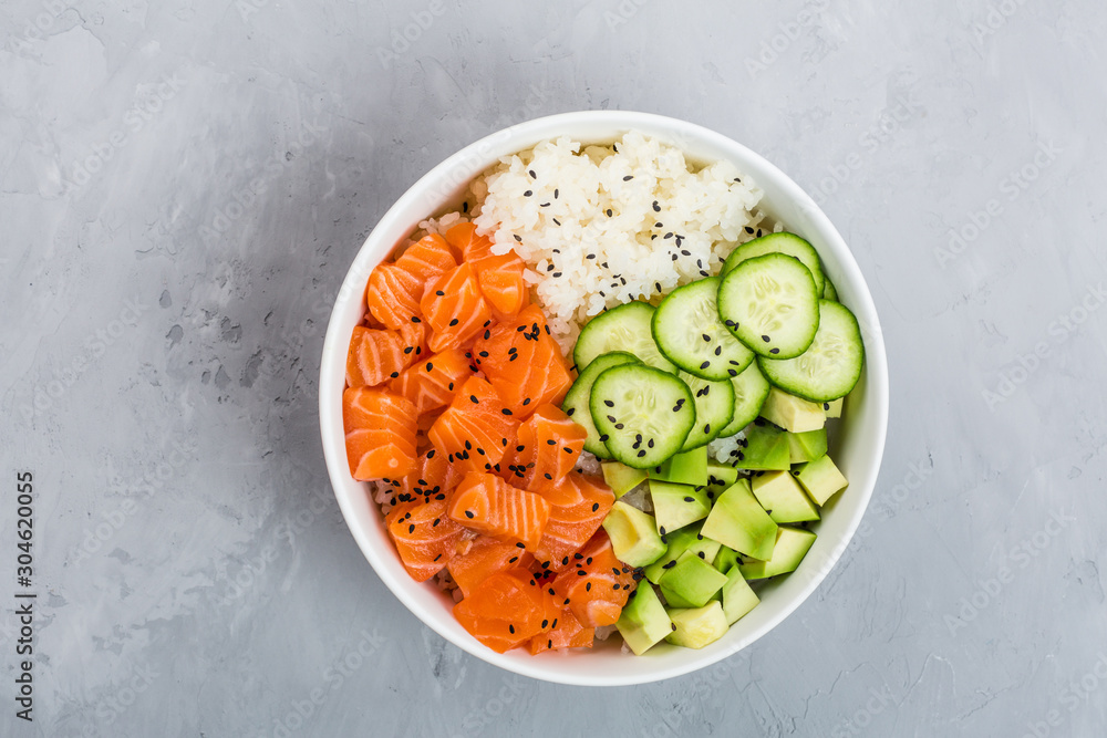 Hawaiian salmon bowl with cucumbers, avocado, sesame seeds and rice