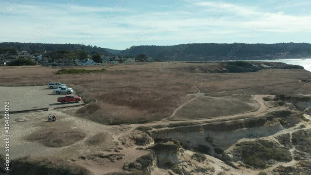 Father and son learning to fly a drone over Mendocino Headlands State Park parking lot. Father and son learning to fly a drone over Mendocino Headlands State Park parking lot.