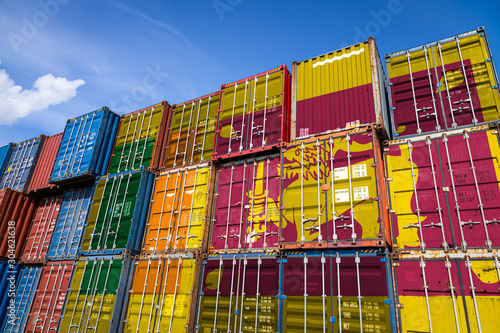 The national flag of Sri Lanka.on a large number of metal containers for storing goods stacked in rows on top of each other. Conception of storage of goods by importers, exporters