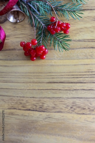 Christmas wooden background with fir tree and red berries