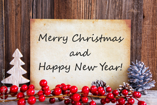 Paper With English Text Merry Christmas And Happy New Yea. Christmas Decoration And Wooden Background