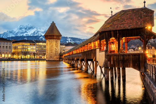 Bild auf Leinwand Lucerne city, historical Chapel bridge on sunset