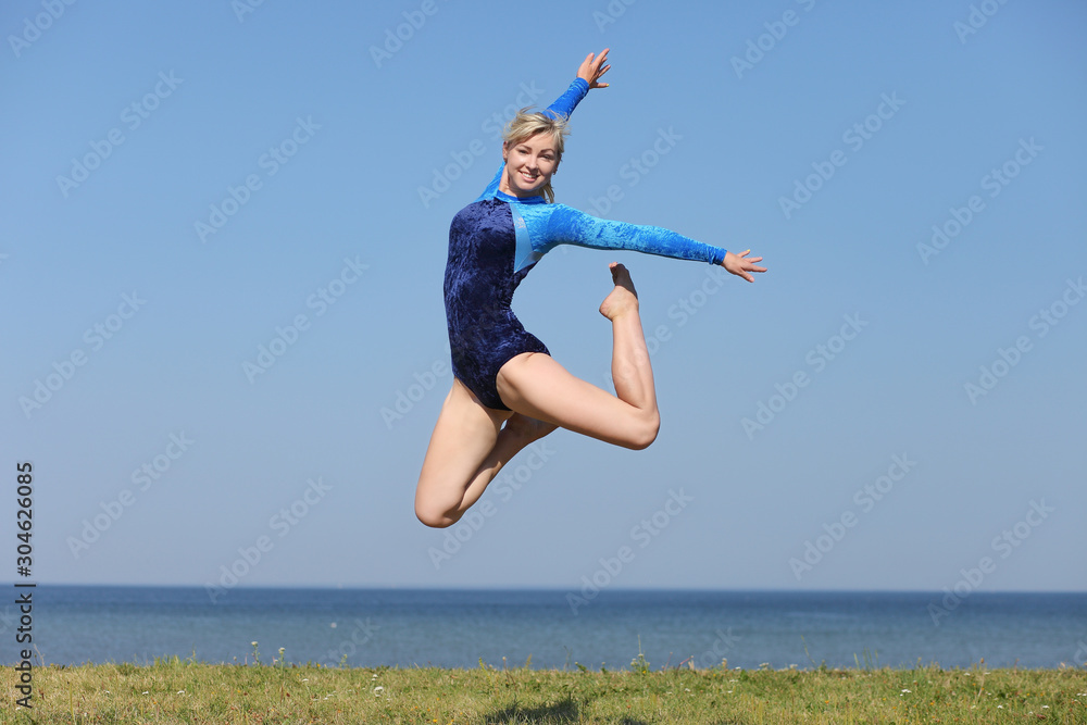 girl gymnast in a blue bodysuit girl gymnast in a blue bodysuit