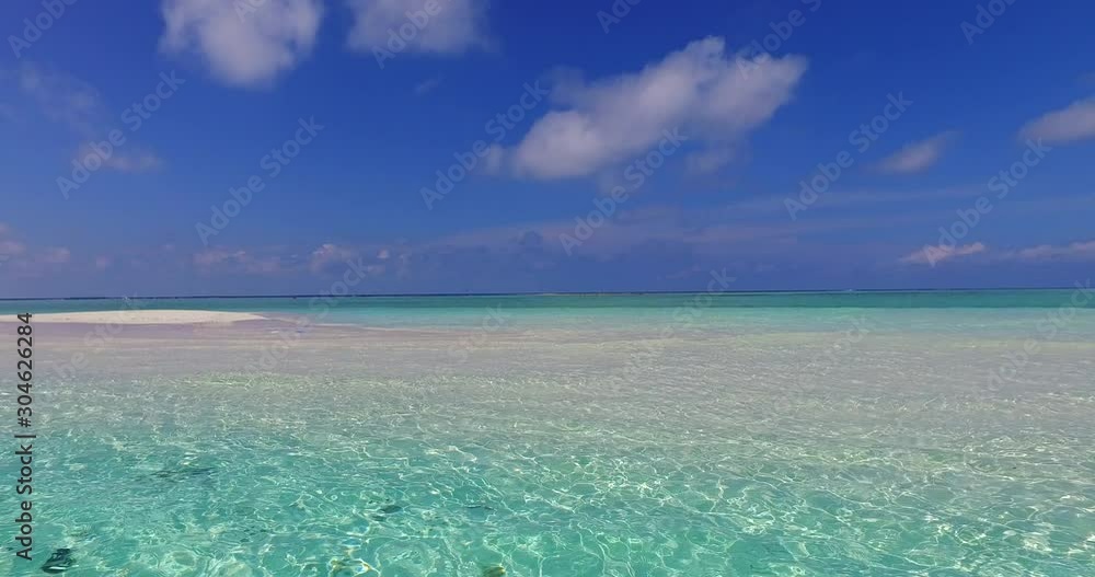 Bahamas, North America - The White Sand Beach Surrounded By The Shallow Light Blue Ocean Under The Bright Cloudy Sky - Wide Shot Bahamas, North America - The White Sand Beach Surrounded By The Shallow Light Blue Ocean Under The Bright Cloudy Sky - Wide Shot