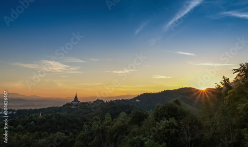 Mountain view panorama evening of Crystal Pagoda or Chedi Kaew on top hill with red sun light and blue sky background  sunset at Wat Tha Ton  Tha Ton District  Fang  Chiang Mai  northern of Thailand.