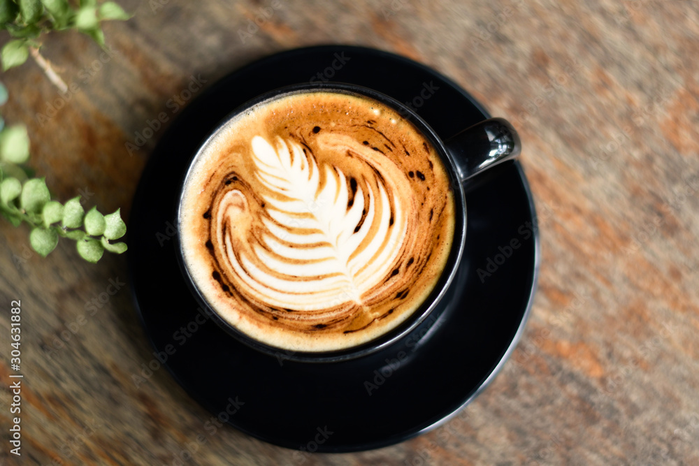 ็High angle view, Coffee latte art on wooden table. ็High angle view, Coffee latte art on wooden table.