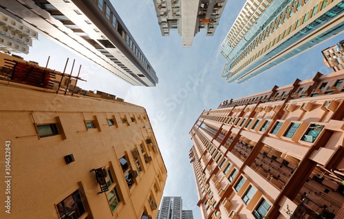 Low angle view of high-rise residential towers with crowded narrow apartments in a community near Central-Mid-Levels Escalator & Walkway system in Hong Kong, a phenomenon of severe housing shortage photo