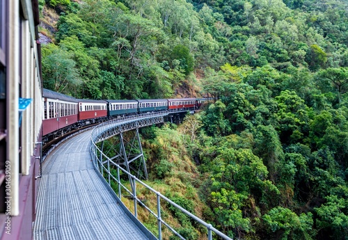 Valokuvatapetti Beautiful shot of Kuranda scenic railway surrounded by green tree forests in Aus