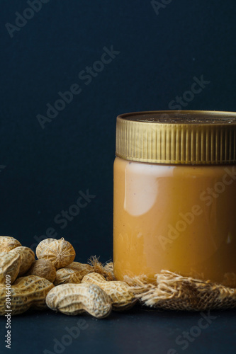 Peanut butter with the peanuts over black background.this peanut also kown as ground nut. selective focus photo