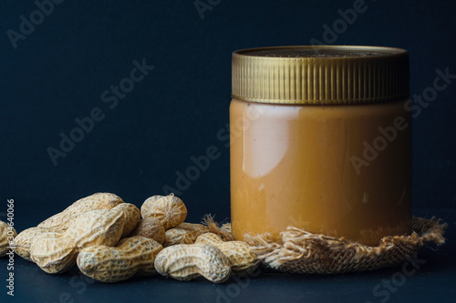 Peanut butter with the peanuts over black background.this peanut also kown as ground nut. selective focus photo