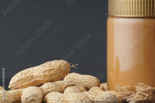 Peanut butter with the peanuts over black background.this peanut also kown as ground nut. selective focus photo