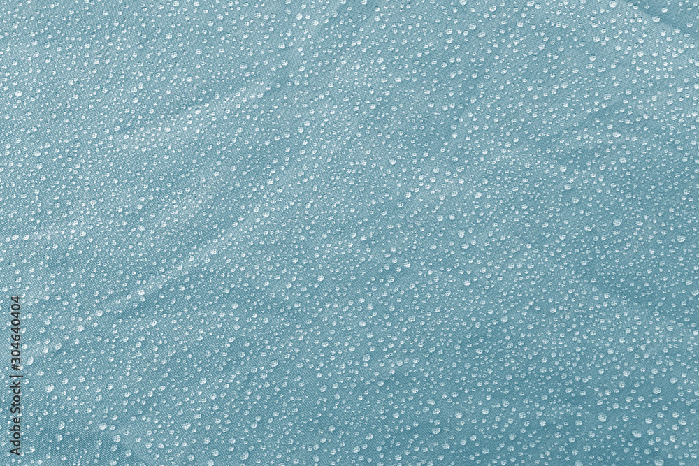 Obraz premium Condensate water droplets on the surface of the material blue