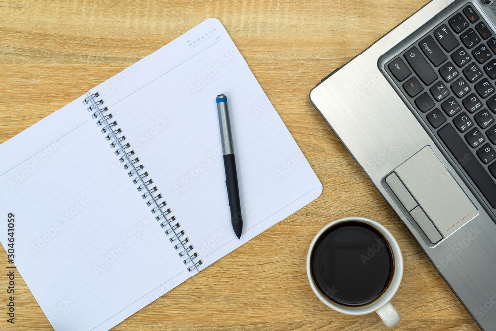 Laptop computer or notebook, note and cup of coffee on working table with copy space top view. Laptop computer or notebook, note and cup of coffee on working table with copy space top view.