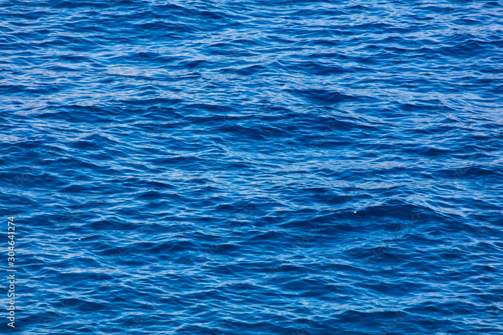 Blue expanse of water at sea as abstract background