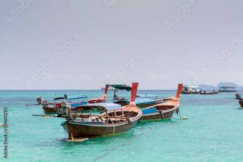 Koh Lipe  Andaman sea  Thailand. Beautiful Island of Koh Lipe  Long-tailed boat parking during Sunrise and Sunset by the beach. Beautiful white beach  blue sea with long tail boats in summer.