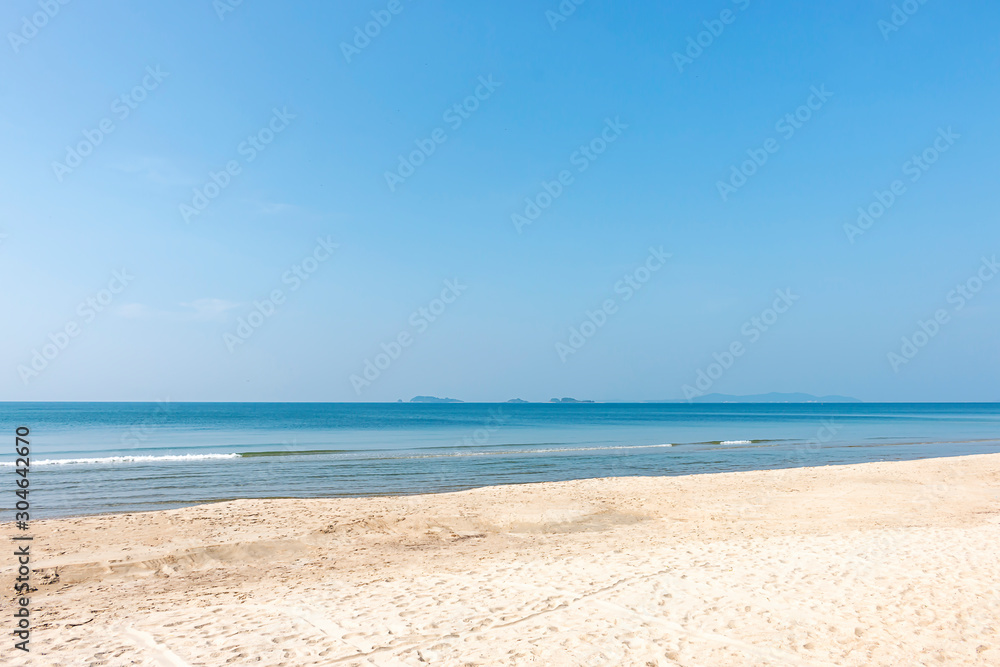The beach is clean and white and beautiful and clear blue sea.