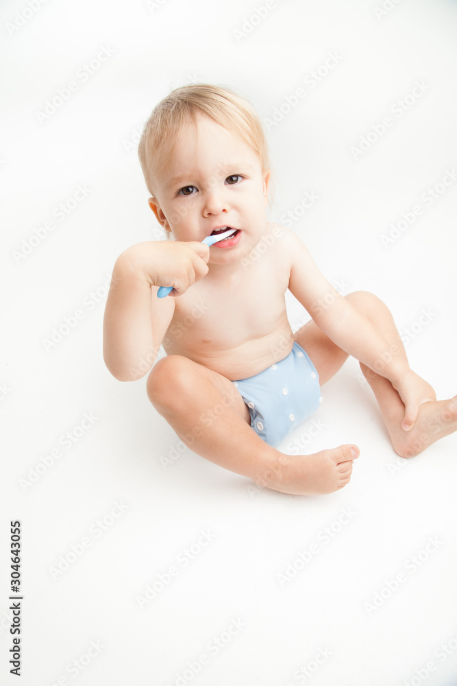 Little boy brushing his teeth on white background Little boy brushing his teeth on white background