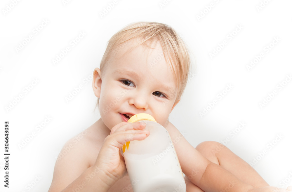 Smiling baby 18 months drinking bottled milk Smiling baby 18 months drinking bottled milk