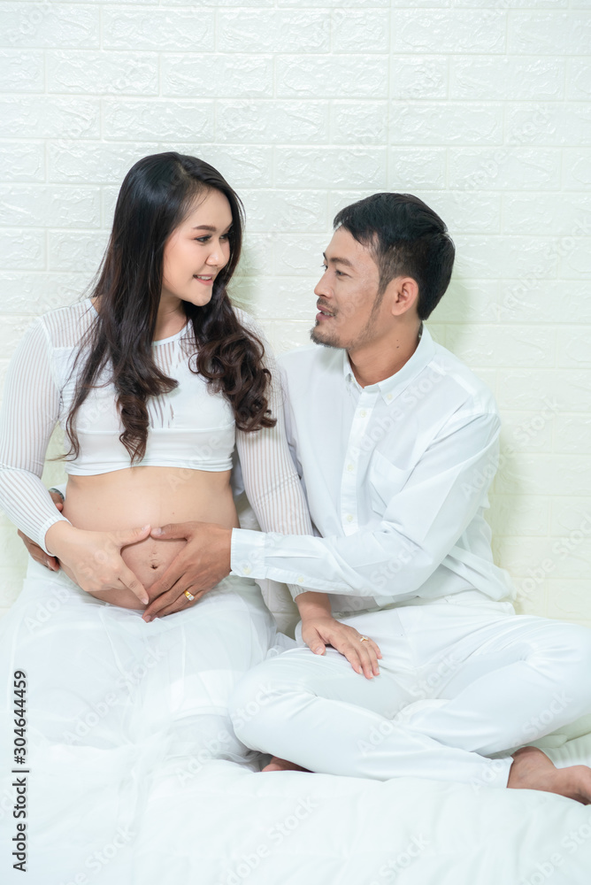 A young man who is happy with his pregnant girlfriend and family who are hoping to have children. A young man who is happy with his pregnant girlfriend and family who are hoping to have children.
