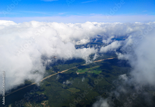 Clouds above the ground view from an airplane as a background © schankz