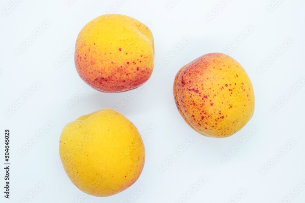 Delicious beautiful apricots located on a white background