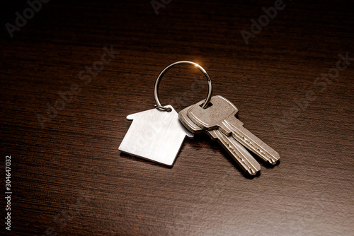 The symbol of the house lies on a brown wooden background