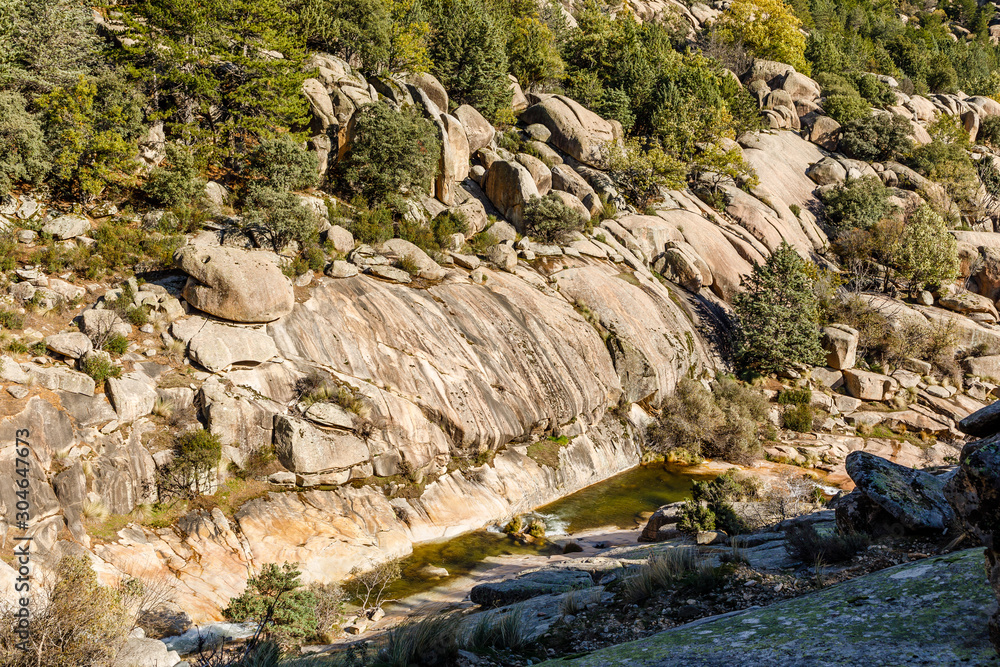 River in La Pedriza, in the mountains of Madrid, area characterized by large granite rocks
