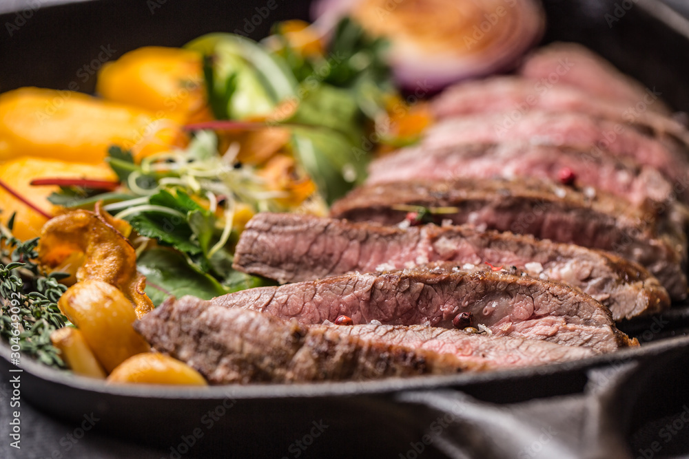 Beef flank steak in grill pan with batata puree garlic and herb decoration Beef flank steak in grill pan with batata puree garlic and herb decoration