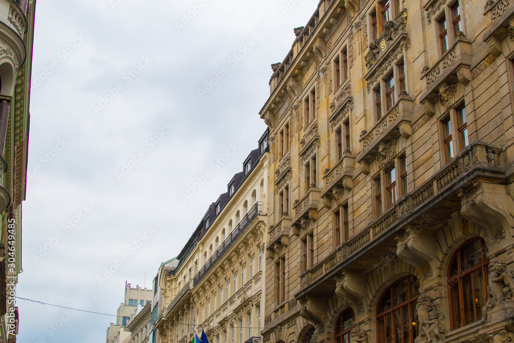 Facade of a typical colorful classic building in a street in middle of Prague, Czech Republic