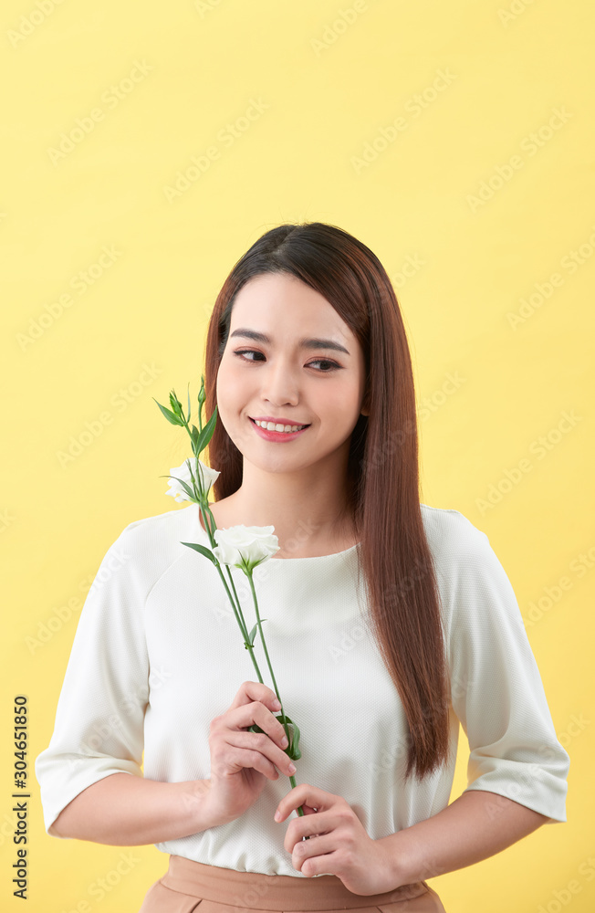 Close up portrait of an attractive young woman holding flower Close up portrait of an attractive young woman holding flower