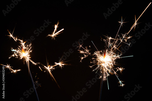Lights of two sparklers with black background