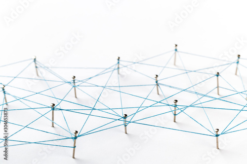Communication, technology, network concept. Network with pinsA large grid of pins connected with string. Communication, technology, network concept. Network with pins