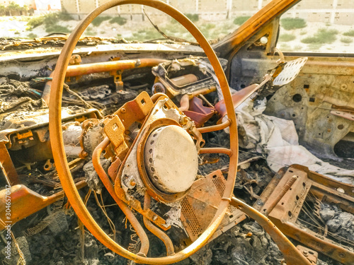 old and rusty burnt car park side of the street after the deadliest accident  © Ali Magsi