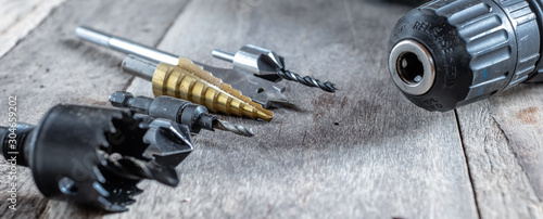 Variety of different types of bit drill displyed on old wooden background. Selective focus. photo